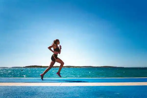 Woman running showing strong leg muscle Hucknall